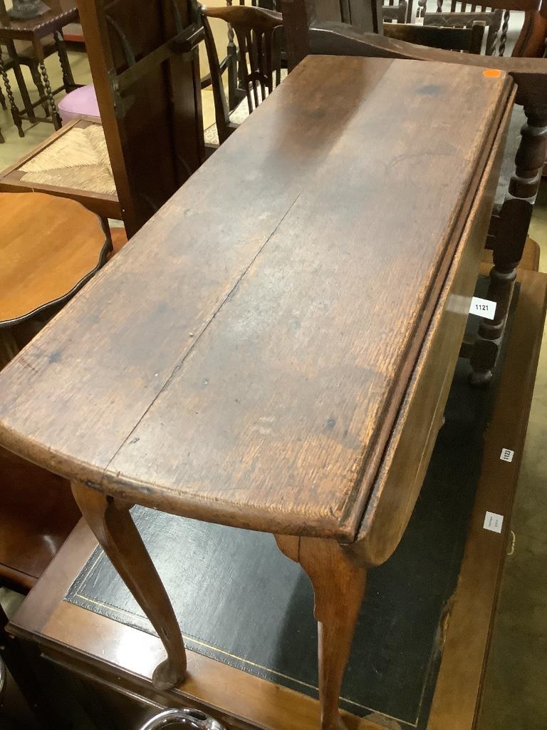 An early 18th century oak oval topped gateleg dining table